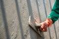 closeup hand of worker plastering cement at wall for building house Royalty Free Stock Photo