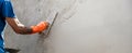 closeup hand of worker plastering cement at wall for building house Royalty Free Stock Photo