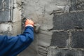 closeup hand of worker plastering cement at wall for building house Royalty Free Stock Photo