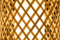 Closeup hand-woven bamboo table lamp with warm and cozy light.