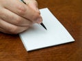 Closeup hand writing blank memo book Royalty Free Stock Photo