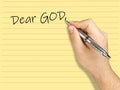 Closeup hand writing letter to GoD on lined sheet Royalty Free Stock Photo