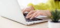 Closeup of hand young asian businesswoman working on laptop computer on desk at home office. Royalty Free Stock Photo