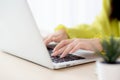 Closeup of hand young asian businesswoman working on laptop computer on desk at home office. Royalty Free Stock Photo