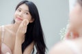 Closeup hand of young asian woman holding product cosmetic applying cream in jar, beautiful girl hand touch lotion. Royalty Free Stock Photo