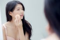 Closeup hand of young asian woman holding product cosmetic applying cream in jar. Royalty Free Stock Photo