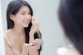 Closeup hand of young asian woman holding product cosmetic applying cream in jar