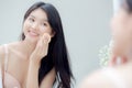 Closeup hand of young asian woman holding product cosmetic applying cream in jar. Royalty Free Stock Photo