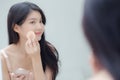 Closeup hand of young asian woman holding product cosmetic applying cream in jar. Royalty Free Stock Photo