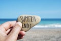 Man on the beach and text summer ends in a stone Royalty Free Stock Photo