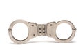 Closeup handcuffs closed bars police white background Royalty Free Stock Photo