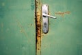 Closeup of a handle on a rusted metal door Royalty Free Stock Photo