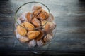 closeup handmade baked nuts with boiled condensed milk in glass jar