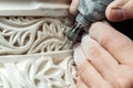 Crop hand grinding stucco ornament