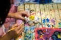 students learning paint on wood animal doll in the art classroom