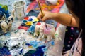 Students learning paint on wood animal doll