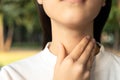 Closeup of hands of asian female people holding her inflamed throat or tonsillitis,child girl touch the neck with her hands,woman Royalty Free Stock Photo