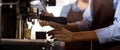 Closeup hands of barista preparing making coffee cappuccino or latte while pouring milk in coffee cup in cafe, close-up young Royalty Free Stock Photo