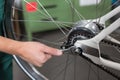 Closeup of the hands of bicycle mechanic at work Royalty Free Stock Photo