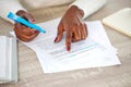 Closeup, hands and black woman with documents, notes and lawyer checking contract, highlight and reading. Zoom, female