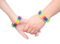 Closeup hands with a bracelet patterned as the rainbow flag. isolated on white Royalty Free Stock Photo