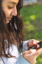 Closeup of the hands of a brunette latina teen girl using a cell phone Royalty Free Stock Photo