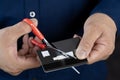 Closeup of the hands of a businessman cutting a credit card with scissors Royalty Free Stock Photo