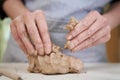 Closeup hands of ceramic artist wedging clay in art studio Royalty Free Stock Photo