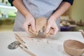 Closeup hands of ceramic artist wedging clay in art studio Royalty Free Stock Photo