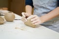 Closeup hands of ceramic artist wedging clay on a desk in art studio Royalty Free Stock Photo