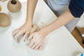 Closeup hands of ceramic artist wedging clay on a desk in art studio Royalty Free Stock Photo