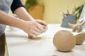 Closeup hands of ceramic artist wedging clay on a desk in art studio Royalty Free Stock Photo