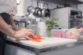 Closeup hands chef kitchen, cutting tomatoes