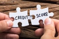Hands Connecting Credit Score Jigsaw Pieces