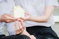 Closeup hands of an couple students holding a little house together, Concept of sustaining a house between two people.