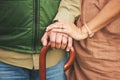 Closeup, hands and couple with support, cane and retirement with solidarity, marriage or appreciation. Zoom, touching or