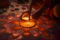 Closeup of hands creating intricate rangoli