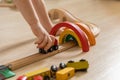 Closeup hands cute baby boy playing wooden rainbow arch railways eco friendly Montessori materials Royalty Free Stock Photo