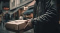 Closeup hands of delivery man holding package to deliver. Courier hand holding brown box isolated. AI generated Royalty Free Stock Photo