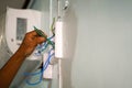 Closeup hands of electrician connecting electrical equipment and wiring within the construction site Royalty Free Stock Photo