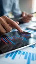Hands interact with tablet displaying financial trends, highlighting analysis Royalty Free Stock Photo