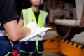 Closeup hands engineer man and woman or worker checking electric train for planning maintenance writing document.