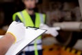 Closeup hands engineer man and woman or worker checking electric train for planning maintenance writing document on clipboard.