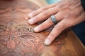 closeup of hands engraving intricate designs on copper Royalty Free Stock Photo