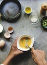 Closeup of hands with fork beating eggs prepare to be cooked