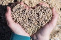 Closeup of hands that form a heart from the sand. Royalty Free Stock Photo