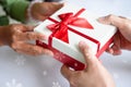 Closeup of hands giving gift box in Christmas day and new year festival to each other. Holiday and event. Surprising giftbox in Royalty Free Stock Photo