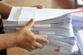 Closeup hands hold stack of used paper to recycle or combine to use next time to print out both sides of paper. Royalty Free Stock Photo