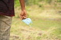 Closeup of hands holding medical mask with copy space - concept of removing mask to feel nature during coronavirus or covid-19