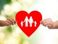 Closeup of hands holding red heart with family Royalty Free Stock Photo
